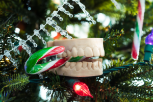 a teeth model Christmas ornament biting a candy cane