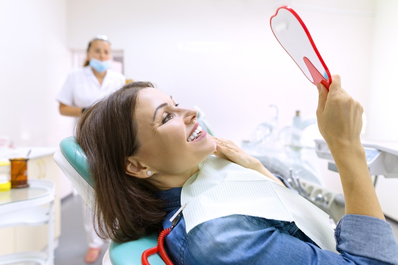 Patient smiling after full mouth reconstruction